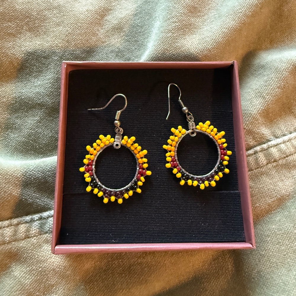 Round yellow beaded sunburst earrings